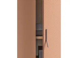 Swing door wardrobe with smooth door, interior in oak, doors in matte lacquered copper.