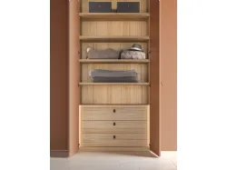 Swing door wardrobe with smooth door, interior in oak, doors in matte lacquered copper.