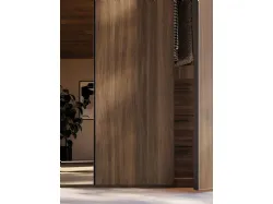 Sliding door wardrobe with Noto door. Interior in terracotta, doors in terracotta material and bronzed mirror.