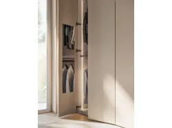 Hinged wardrobe front in Tortora laminate and recessed handle in matte lacquered Ecru.