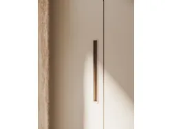 Swing door wardrobe in Tortora melamine and recessed handle in matte lacquered Ecru.