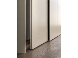 Sliding wardrobe with Arka door. Interior in terracotta, doors in Avana melamine decor.