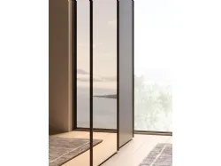 Sliding wardrobe with internal cotton lining, doors in matte clay lacquer, and bronzed mirror.