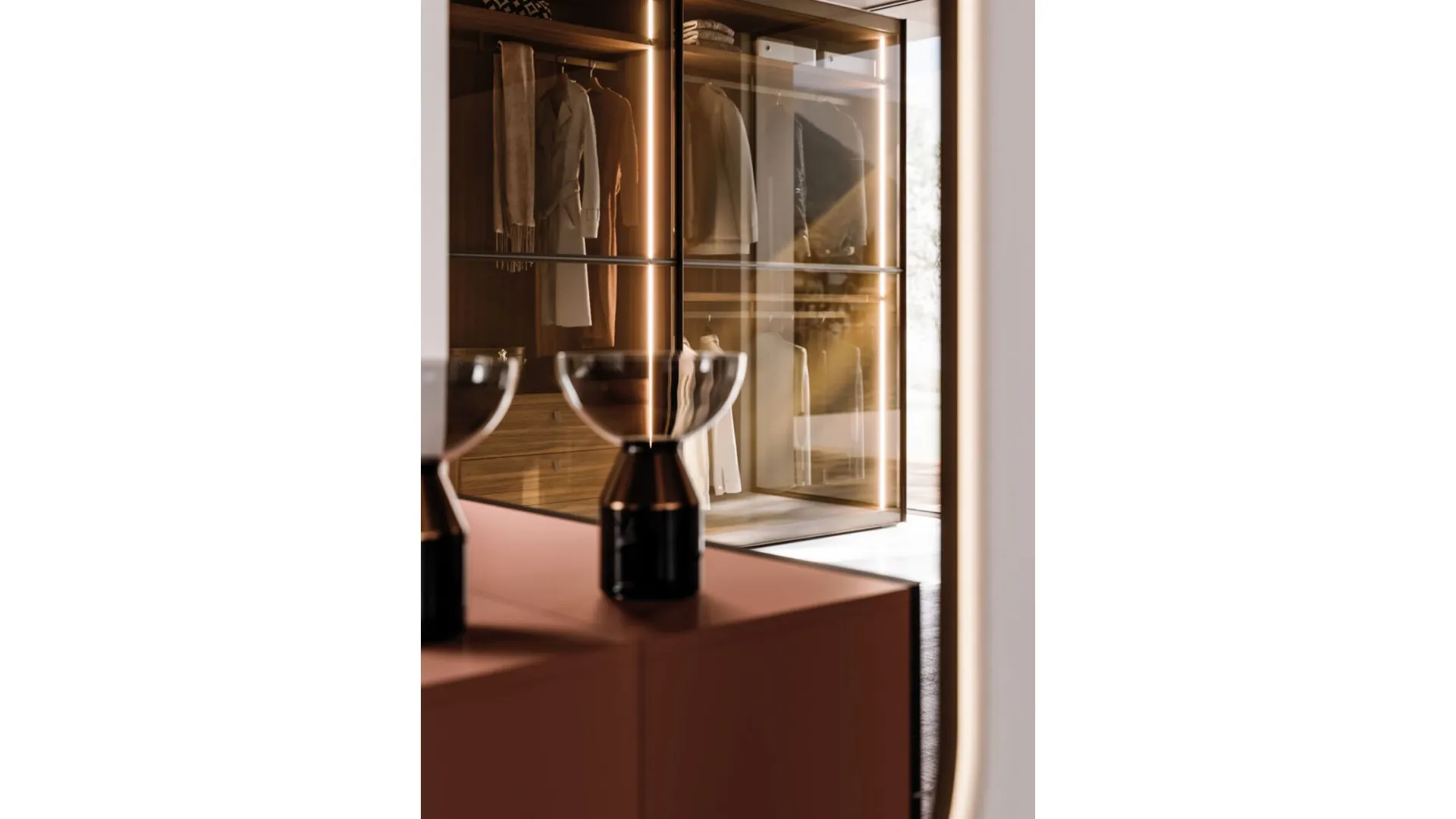 Sliding wardrobe with Frame door. Interior in terracotta, Frame doors in bronzed glass and burnished metal.