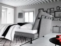 Spacious matrimonial bed of Noah with soft cushions on the headboard.